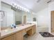 This bright bathroom features a double sink vanity, soaking tub, and glass door shower at 30029 Pga Dr, Sorrento, FL 32776