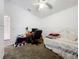 Bright bedroom featuring neutral carpet, white furniture, and ceiling fan at 30029 Pga Dr, Sorrento, FL 32776