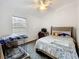 Bedroom featuring neutral carpet, queen size bed, and window with natural light at 30029 Pga Dr, Sorrento, FL 32776
