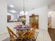 Dining room showcasing wooden chairs and open view to kitchen and pantry at 30029 Pga Dr, Sorrento, FL 32776