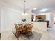 Dining area with wooden chairs and a view of the kitchen at 30029 Pga Dr, Sorrento, FL 32776