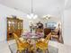 Cozy dining room featuring hardwood furniture, decorative rug, and lots of natural light at 30029 Pga Dr, Sorrento, FL 32776