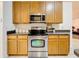 Modern kitchen features stainless steel oven, microwave, and wood cabinets at 30029 Pga Dr, Sorrento, FL 32776
