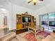 Living room featuring hardwood floors, TV entertainment center, and view to the screened-in patio at 30029 Pga Dr, Sorrento, FL 32776