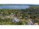 Expansive aerial view showcasing a lakeside community surrounded by lush greenery and waterfront homes at 3005 Garden Rd, Eustis, FL 32726