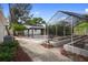 Landscaped backyard featuring a gardening shed, gazebo and a greenhouse, offering a serene outdoor space at 3005 Garden Rd, Eustis, FL 32726