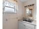 Bright bathroom features a vanity with cabinet storage, neutral wall color, and a large mirror at 3005 Garden Rd, Eustis, FL 32726