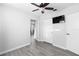 Bedrooms features wood-look floors, ceiling fan, window, and television at 3005 Garden Rd, Eustis, FL 32726