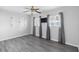 This bedroom offers wood-look floors, two windows and a ceiling fan at 3005 Garden Rd, Eustis, FL 32726