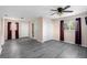 Bedroom with gray laminate flooring, floral wallpaper, closet space, and an ensuite bathroom at 3005 Garden Rd, Eustis, FL 32726