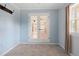 Cozy dining room features gray tile floors, blue accent walls, and french doors that lead to another room at 3005 Garden Rd, Eustis, FL 32726