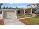 Inviting home with a driveway and attached garage, enhanced by blooming flowers and meticulous landscaping at 3005 Garden Rd, Eustis, FL 32726