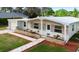 Charming single-story home with stone accents, brick walkway and manicured front garden at 3005 Garden Rd, Eustis, FL 32726