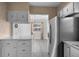 View of the kitchen area featuring a stainless steel refrigerator and marble countertops at 3005 Garden Rd, Eustis, FL 32726