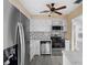 Bright kitchen featuring stainless steel appliances, white cabinets and a ceiling fan at 3005 Garden Rd, Eustis, FL 32726