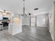 Spacious living area featuring wood-look floors, ceiling fans, and open layout to the kitchen at 3005 Garden Rd, Eustis, FL 32726