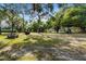 Spacious park area featuring lush greenery, towering trees, and recreational amenities at 3005 Garden Rd, Eustis, FL 32726