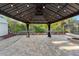 Covered brick patio featuring ambient lighting, offers a relaxing outdoor space surrounded by greenery at 3005 Garden Rd, Eustis, FL 32726
