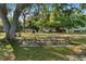 Inviting picnic area with wooden tables, a grill, and shady trees offers a serene outdoor space at 3005 Garden Rd, Eustis, FL 32726