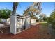 An outdoor shed, complemented by mulch landscaping, adjacent to the backyard patio, provides convenient storage space at 3005 Garden Rd, Eustis, FL 32726