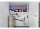 A water heater is in the basement with shelving overhead, installed on the white cinder block wall at 3005 Garden Rd, Eustis, FL 32726