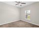 Well-lit carpeted bedroom featuring a window with views of the outdoors at 303 Puffer Ct, Kissimmee, FL 34759