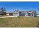 Well-manicured lawn compliments this beautiful gray home with attached two-car garage at 303 Puffer Ct, Kissimmee, FL 34759