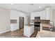 Modern kitchen features white cabinets, stainless steel appliances, and a kitchen island at 303 Puffer Ct, Kissimmee, FL 34759