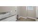 Laundry room featuring a sink, tile flooring, and washer-dryer hookups at 303 Puffer Ct, Kissimmee, FL 34759