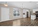 Open living space connects dining and kitchen, featuring hardwood floors and stainless steel appliances at 303 Puffer Ct, Kissimmee, FL 34759