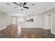 Spacious living area featuring hardwood floors, seamless flow into kitchen, and open floor plan at 303 Puffer Ct, Kissimmee, FL 34759