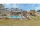 Spacious backyard with a pool, brick patio, and partial fence offering outdoor privacy at 3041 Millstone Ave, Deltona, FL 32738