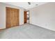 Carpeted bedroom with closet and a doorway providing access to the kitchen at 3041 Millstone Ave, Deltona, FL 32738