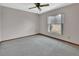 Carpeted bedroom with a window, providing natural light, and neutral walls at 3041 Millstone Ave, Deltona, FL 32738