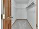 Walk-in closet featuring carpeted floors and white shelving at 3041 Millstone Ave, Deltona, FL 32738