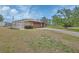 Well-maintained home with a large storage shed and a driveway, providing ample parking space at 3041 Millstone Ave, Deltona, FL 32738