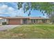 Charming single-story brick home with a well-maintained lawn and a two car garage at 3041 Millstone Ave, Deltona, FL 32738