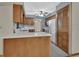 Functional kitchen with lots of cabinet space, white countertops and appliances, and access to the dining area at 3041 Millstone Ave, Deltona, FL 32738