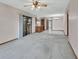 Open-concept living area showcases natural light, carpet, and seamless transition to the kitchen and dining spaces at 3041 Millstone Ave, Deltona, FL 32738