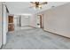 Open living space features plush carpet, a ceiling fan, and easy access to other areas, perfect for entertaining at 3041 Millstone Ave, Deltona, FL 32738