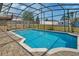 Backyard pool with clean, clear water, surrounded by a brick patio and screen enclosure at 3041 Millstone Ave, Deltona, FL 32738