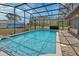Screened pool with crystal clear water and brick-paved deck offers a refreshing backyard oasis at 3041 Millstone Ave, Deltona, FL 32738