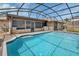 Backyard swimming pool with brick surround and screen enclosure for outdoor enjoyment at 3041 Millstone Ave, Deltona, FL 32738