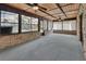 Spacious sunroom featuring brick walls, carpeted floor, wood ceiling, and large windows at 3041 Millstone Ave, Deltona, FL 32738