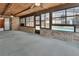 View of a sunroom that leads to the pool, featuring brick walls and carpeted floors at 3041 Millstone Ave, Deltona, FL 32738