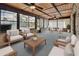 Inviting sunroom with wood ceilings, brick accents, ceiling fans, and an abundance of natural light at 3041 Millstone Ave, Deltona, FL 32738