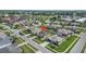 Wide aerial showing house in neighborhood with streets, lawns and waterways at 307 Mariners Gate Dr, Edgewater, FL 32141