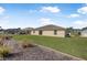 View of backyard, home exterior, patio and landscaping at 307 Mariners Gate Dr, Edgewater, FL 32141