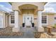 Charming front entrance with decorative columns, a welcoming door, and a beautifully landscaped rock garden at 307 Mariners Gate Dr, Edgewater, FL 32141