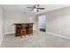 Carpeted bar area with custom bar, two chairs, ceiling fan, and recessed lighting at 3104 Umbrella Tree Dr, Edgewater, FL 32141